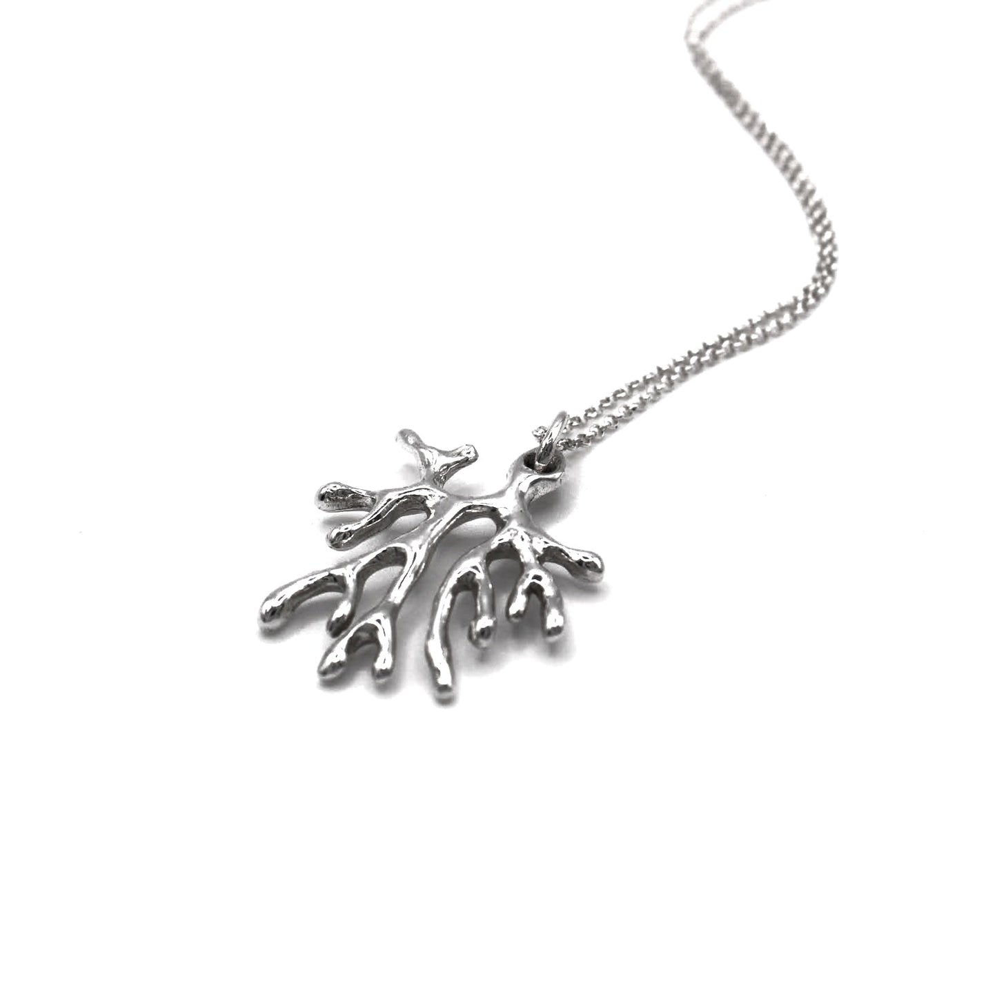 Silver necklace with a leaf-shaped pendant on a white background