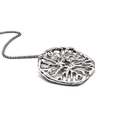Silver necklace with a detailed pendant on a white background
