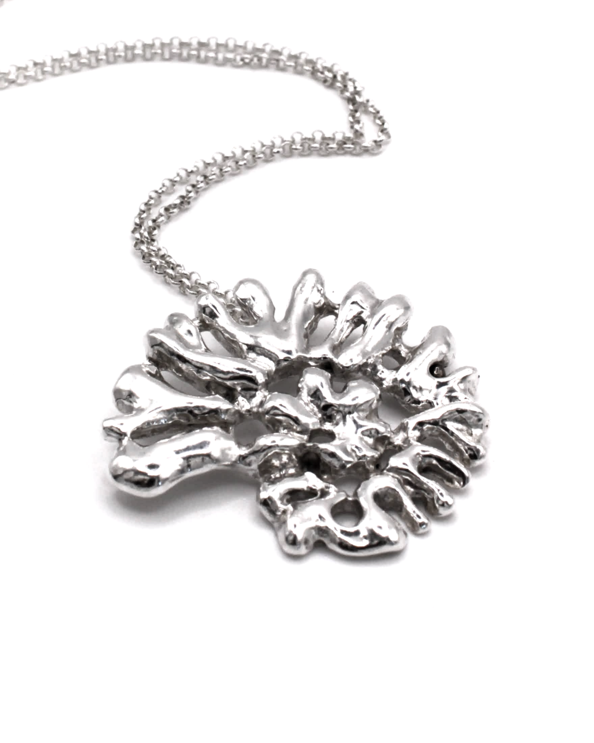 A silver necklace featuring an organic, coral-like textured pendant on a delicate link chain, photographed against a clean white background.