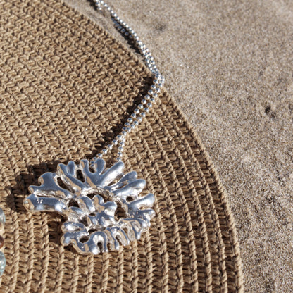 Handmade sterling silver spiral pendant on chain inspired by marine fossils and natural ocean patterns