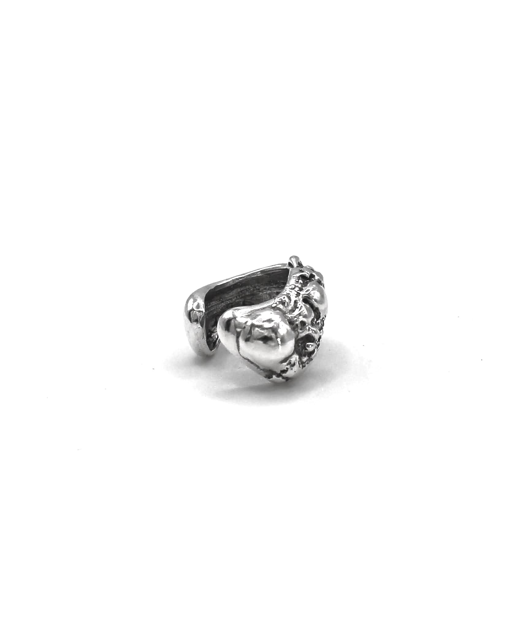 Detailed view of the handcrafted sterling silver Piedra Sorra ear cuff with sculptural surface inspired by sea-shaped stones.
