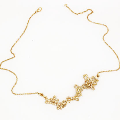 Raíz statement necklace handcrafted in sterling silver with a gold-plated finish. Mediterranean-inspired jewelry featuring a large ocean-inspired pendant with sculptural, organic forms. A bold yet elegant sustainable piece, crafted for nature and contemporary jewelry lovers by Naturalesa.