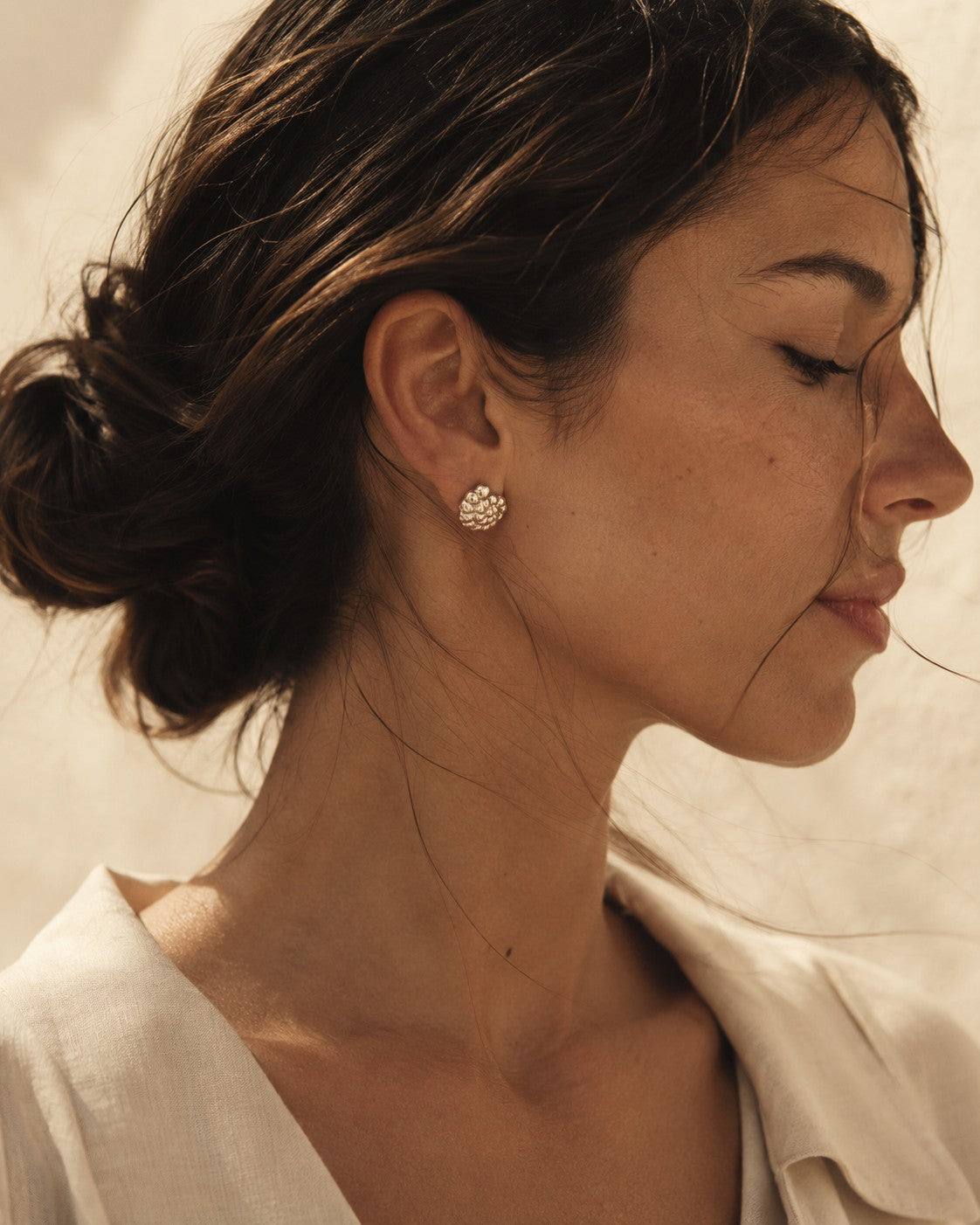Souvenirs Nautilus sterling silver stud earrings worn on ear