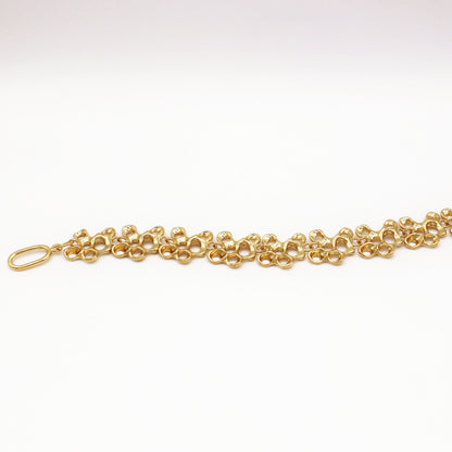 Raíz bracelet handcrafted in sterling silver with a gold-plated finish. Mediterranean-inspired jewelry formed of nine organic-shaped segments with a stylish toggle clasp. A bold yet elegant sustainable bracelet for nature and contemporary jewelry lovers, crafted by Naturalesa.