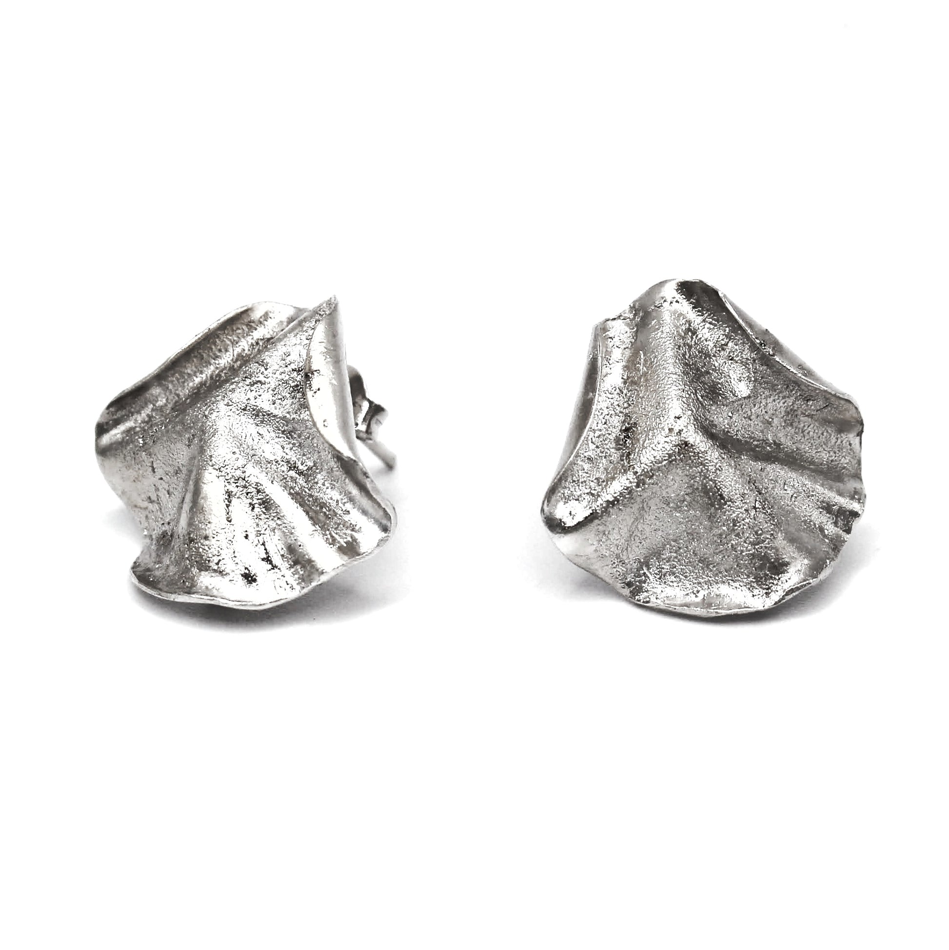 Sculptural folded silver earrings, handcrafted in recycled sterling silver using the lost wax casting technique. Mediterranean-inspired jewelry with organic, wave-like forms and a unique fused silver dust texture. Elegant and sustainable statement earrings for nature and contemporary jewelry lovers, crafted by Naturalesa.
