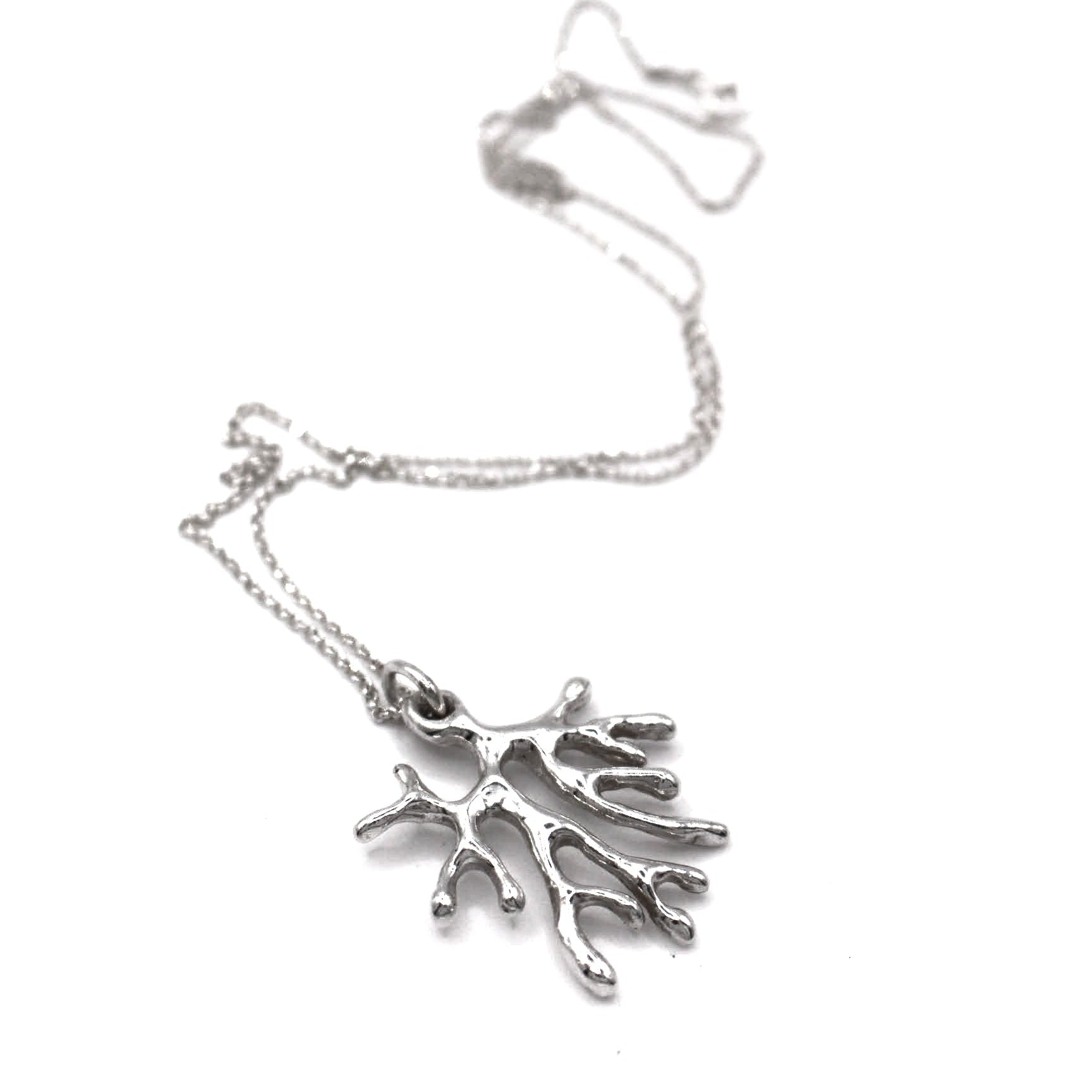 Silver coral-shaped pendant on a chain against a white background