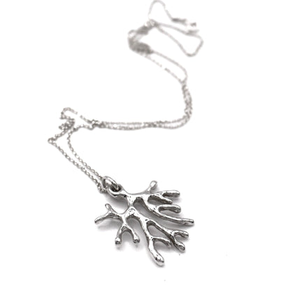 Silver coral-shaped pendant on a chain against a white background